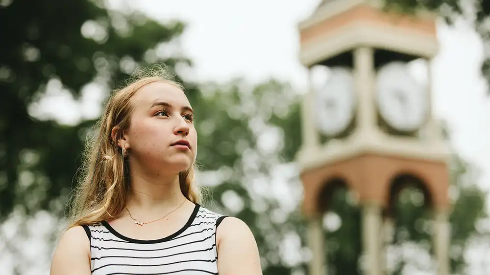Female student and the clock tower.
