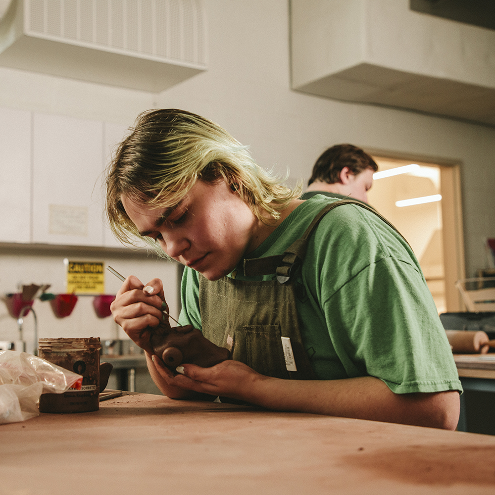 artist at pottery table