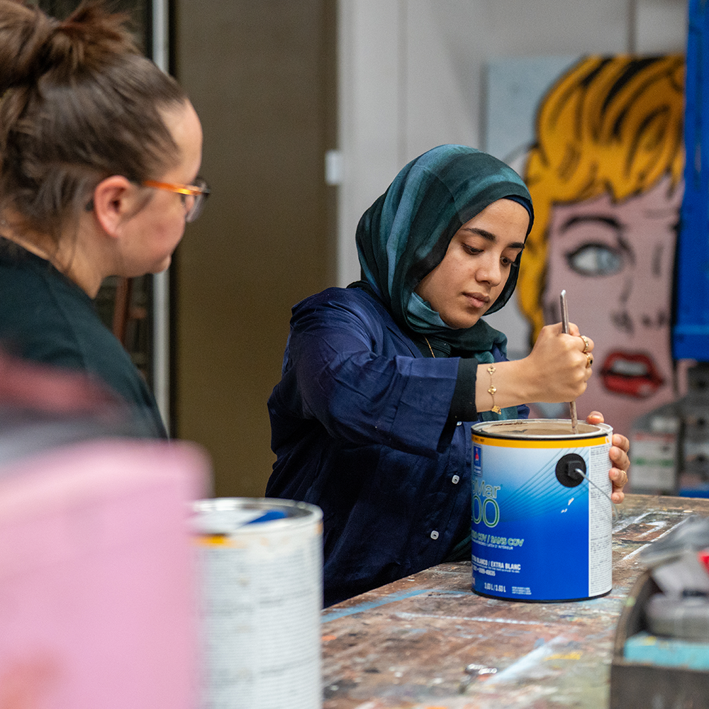 student mixing paint