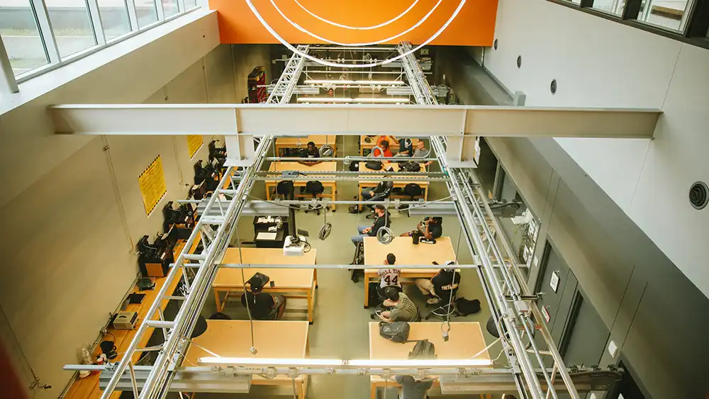 Image looking down into a research area with many desks. 