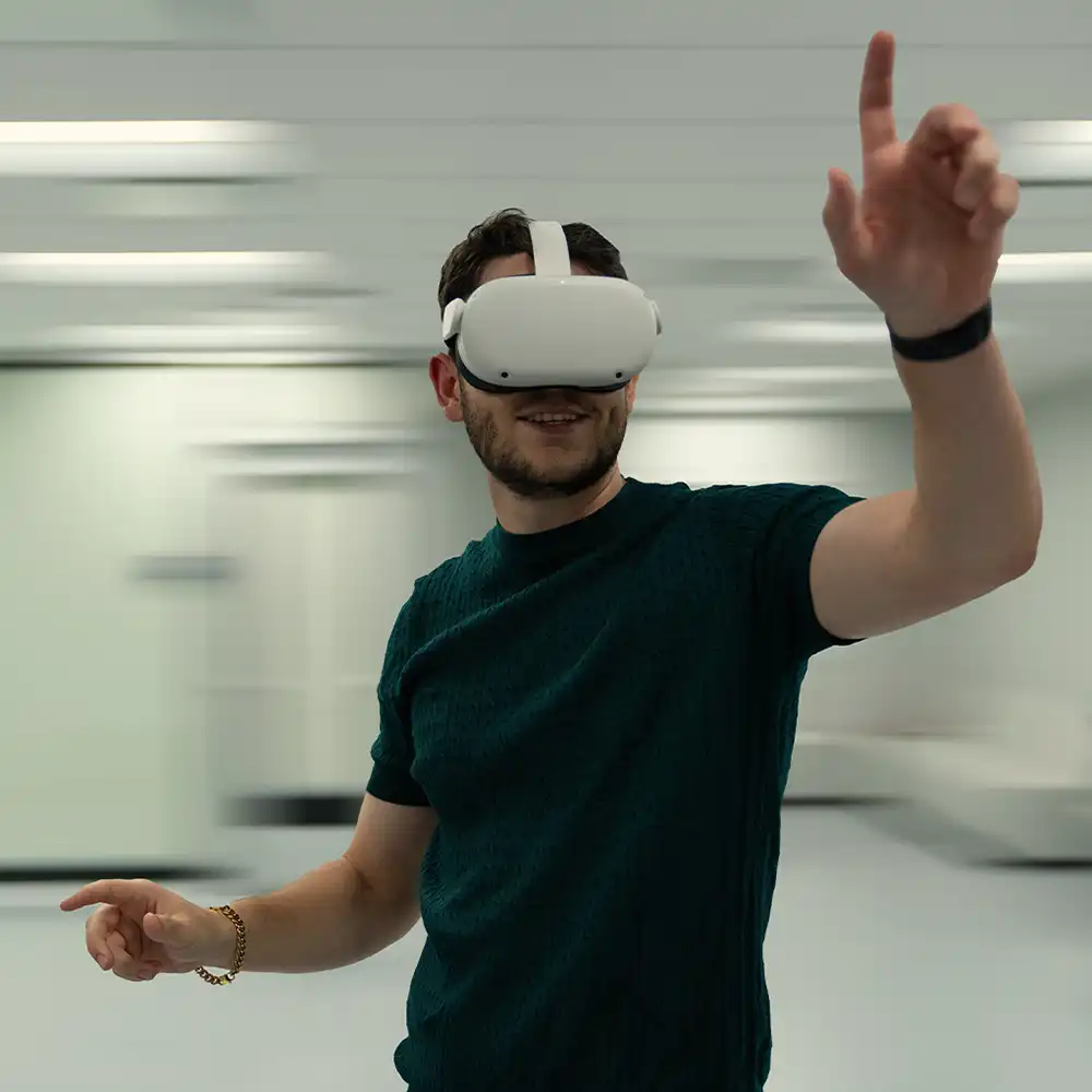 Two women looking at each other, smiling, sitting down, working on an assignment.