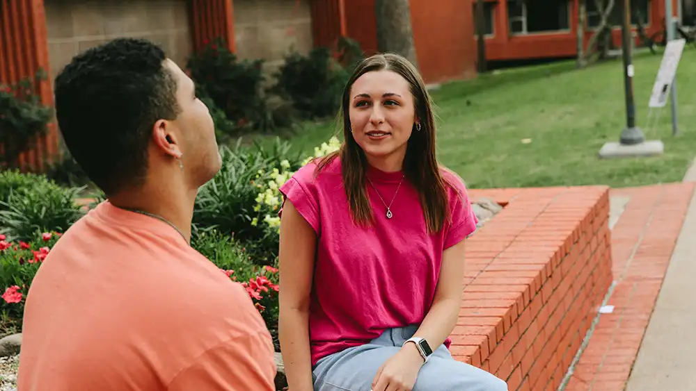 ​​SHSU students engage in conversation on campus.​ 
