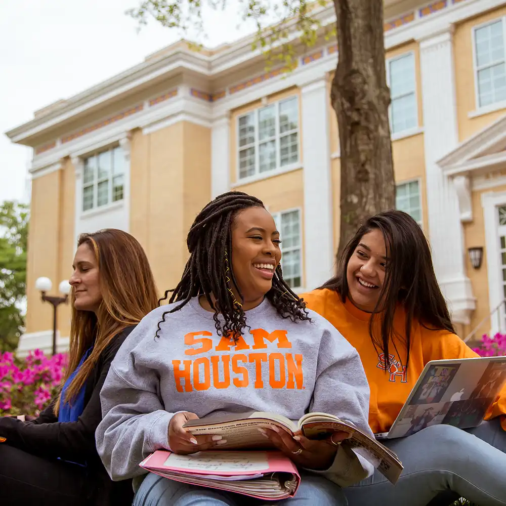 SHSU students study on the lawn in front of Austin Hall.