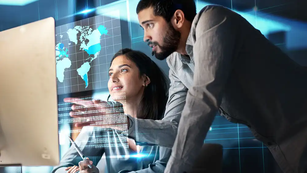 Man and woman working together on a computer. 