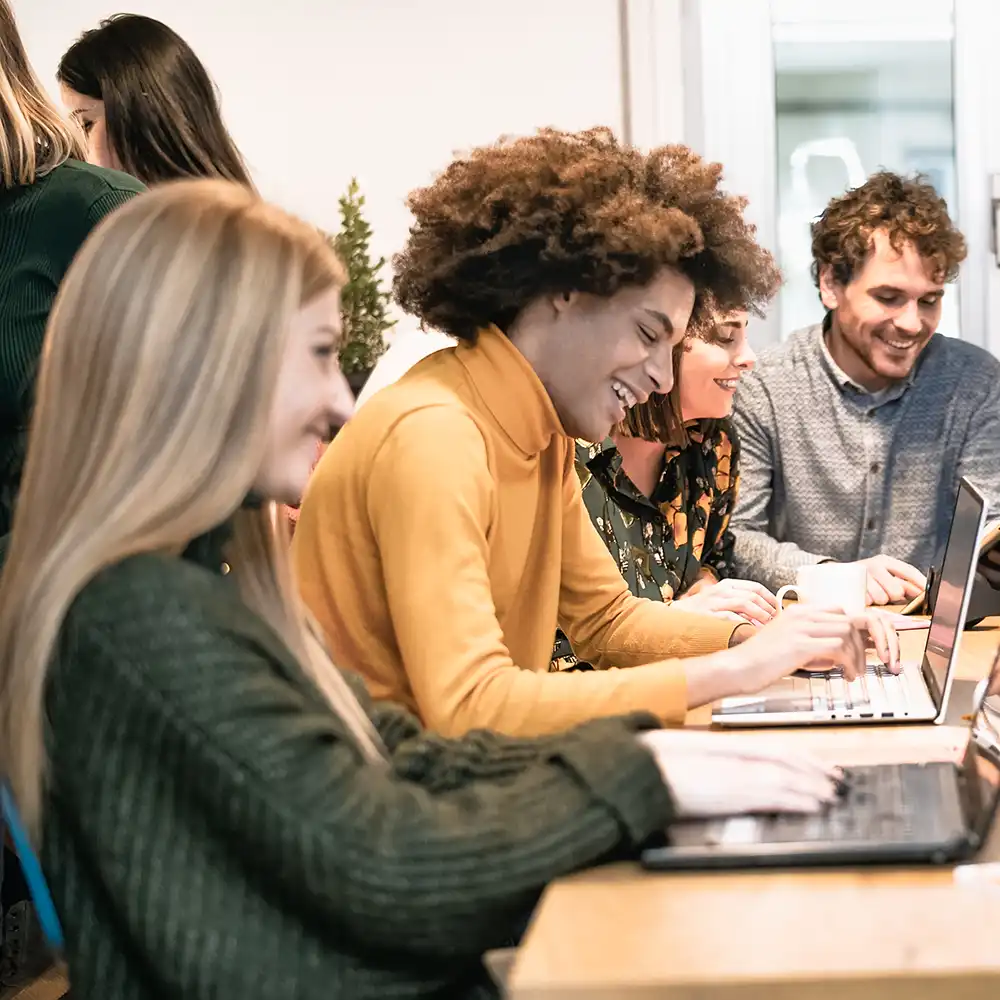 Students gathered around a table and working together. 