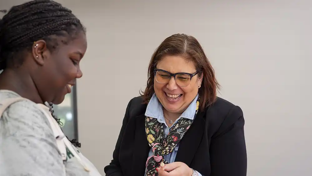 Man in suit talking to another man