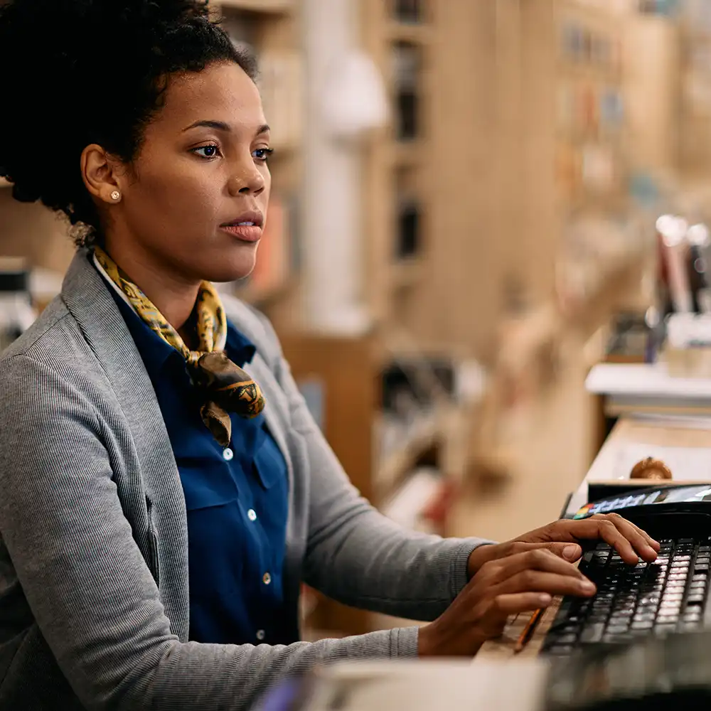 Woman working at a laptop computer.