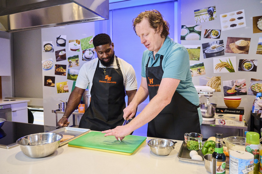 Man in suit talking to another man