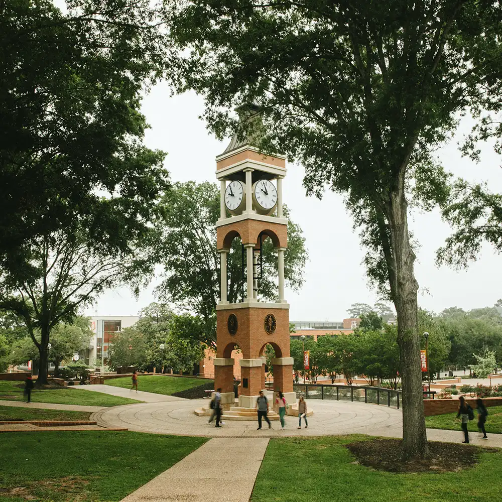 SHSU clocktower with people walking by.