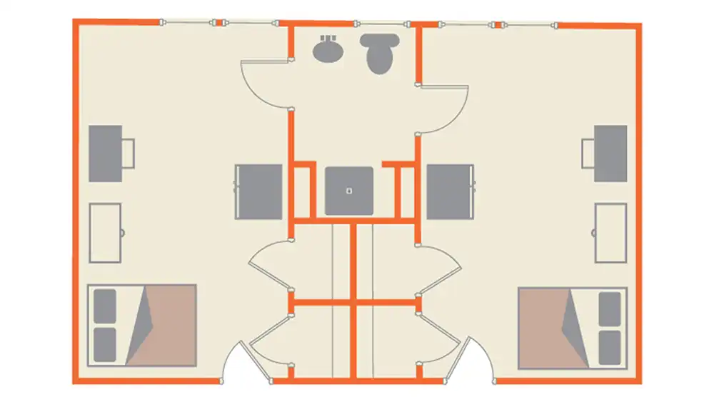 Floor plan of a symmetrical Jackson-Shaver layout featuring two identical sections. Each section includes a bedroom with a full-size bed, dresser, desk, and chair. The room also includes a refrigerator and a microwave. The center of the layout contains a shared bathroom, with a sink and toilet. Hallways and doors connect the rooms, all outlined in orange for clarity. 