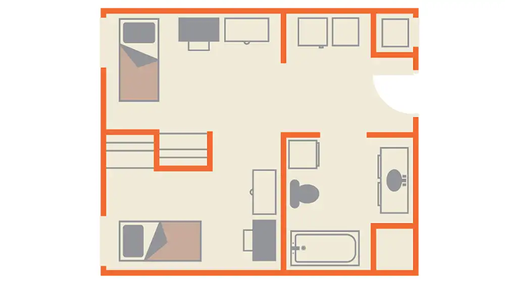 The floor plan of SHSU's Lone Star Hall shows a rectangular layout with two sleeping areas, partially separated by a storage area, and a shared bathroom. The entrance is located on the right side of the plan. Upon entering, there is an open space that serves as the kitchenette area with storage compartments along the walls. Each sleeping area has a dresser, desk, and chair. The bathroom is centrally located at the bottom right corner of the plan and includes a toilet, sink, and shower/bathtub combination. 