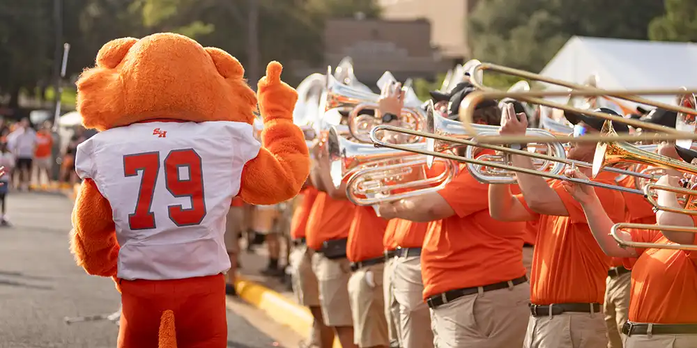 Sammy the Bearkat performing with SHSU Marching Band during the SHSU Tradition, Bearkat Alley.