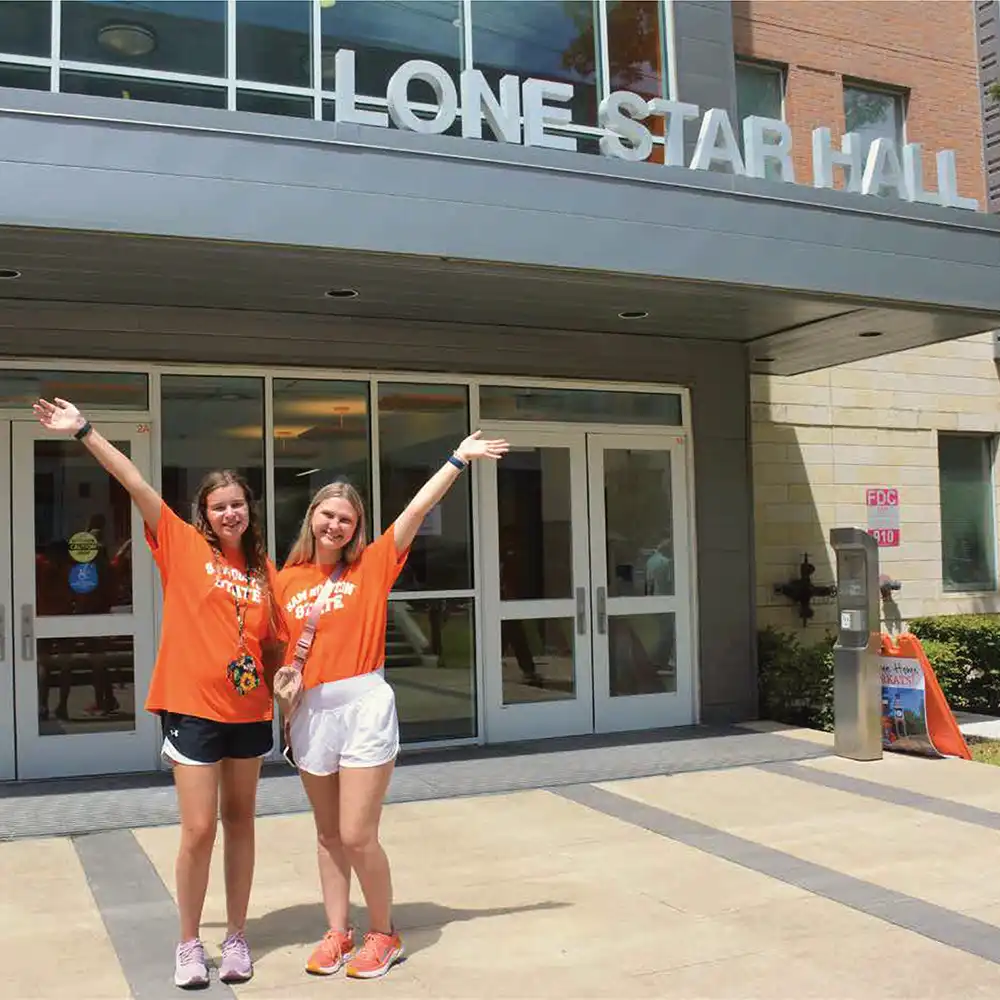 Two female students in front of Lone Star Hall