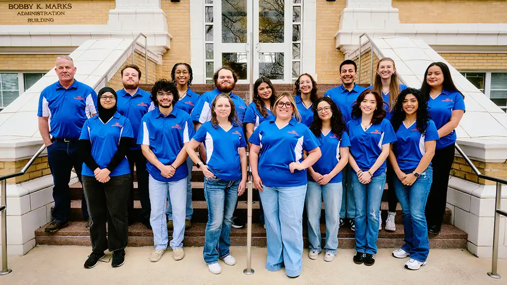 Staff members on stairs outside.