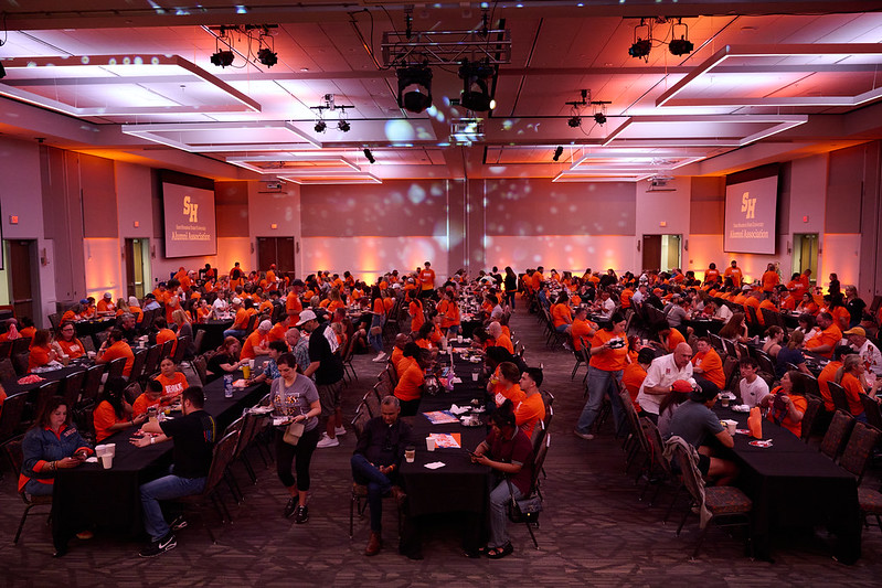 People seated in the orange ball room