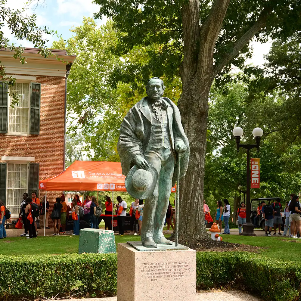 Statue of Sam Houston in front of building