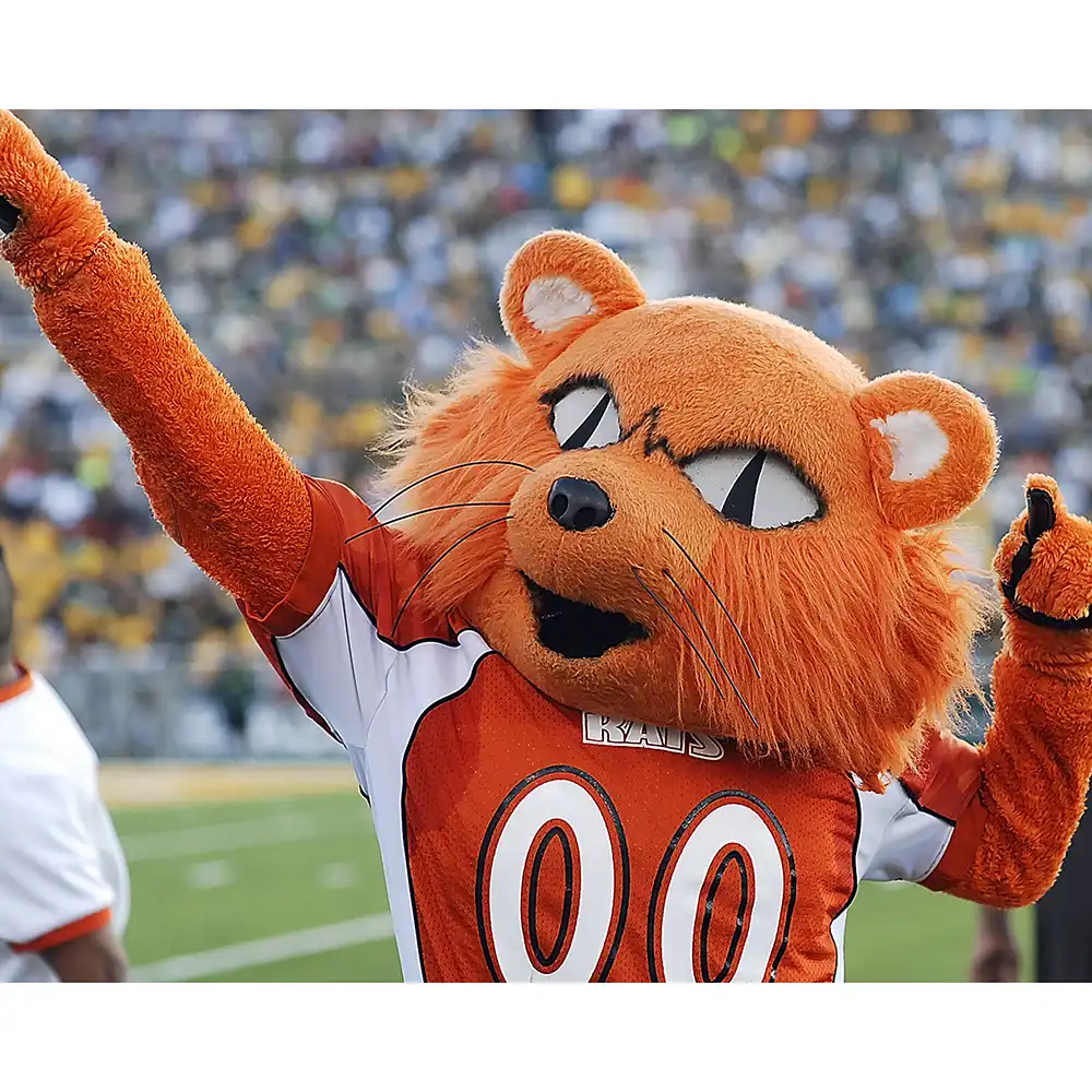 Sammy the Bearkat mascot posing with his right arm pointed outward and left arm by his ear.