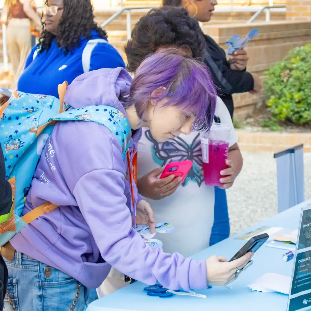 An SHSU student downloading the Symplicity app.