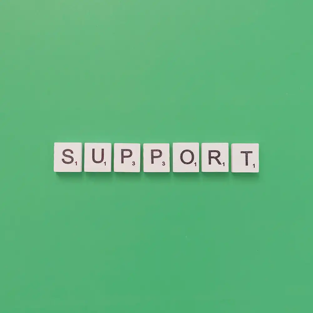 ​​Scrabble tiles that are lined up to spell out “support”​ 