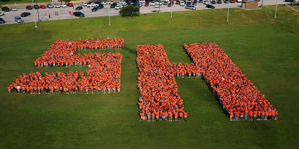 Incoming freshmen start their Bearkat Kickoff journey by gathering for a class photo in the shape of SH.