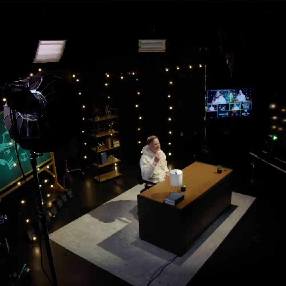 Lecturer in Studio B behind desk.