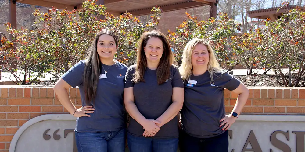 Student Wellness staff members standing outdoors