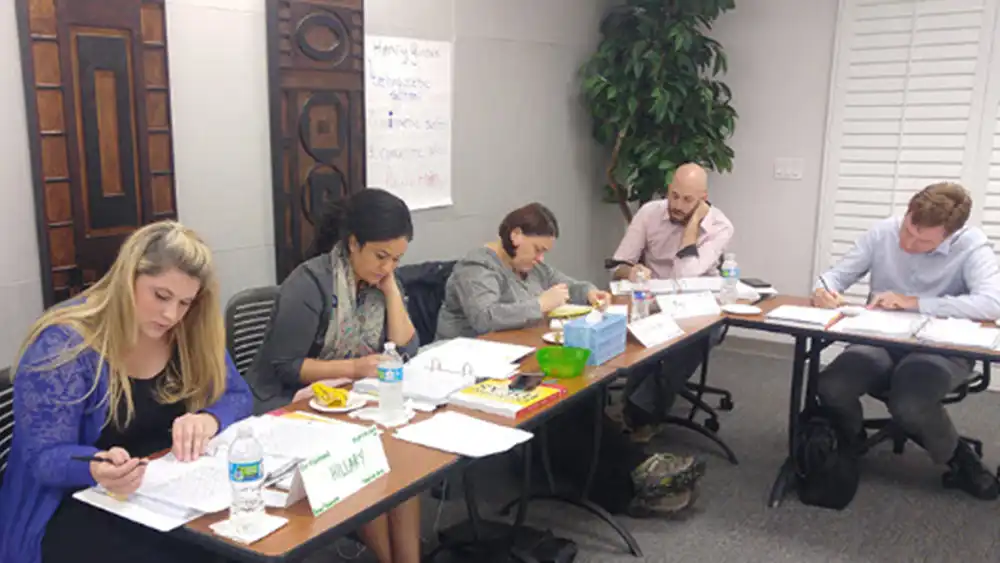 Instructors participate together to learn how to incorporate writing techniques in their curriculum.